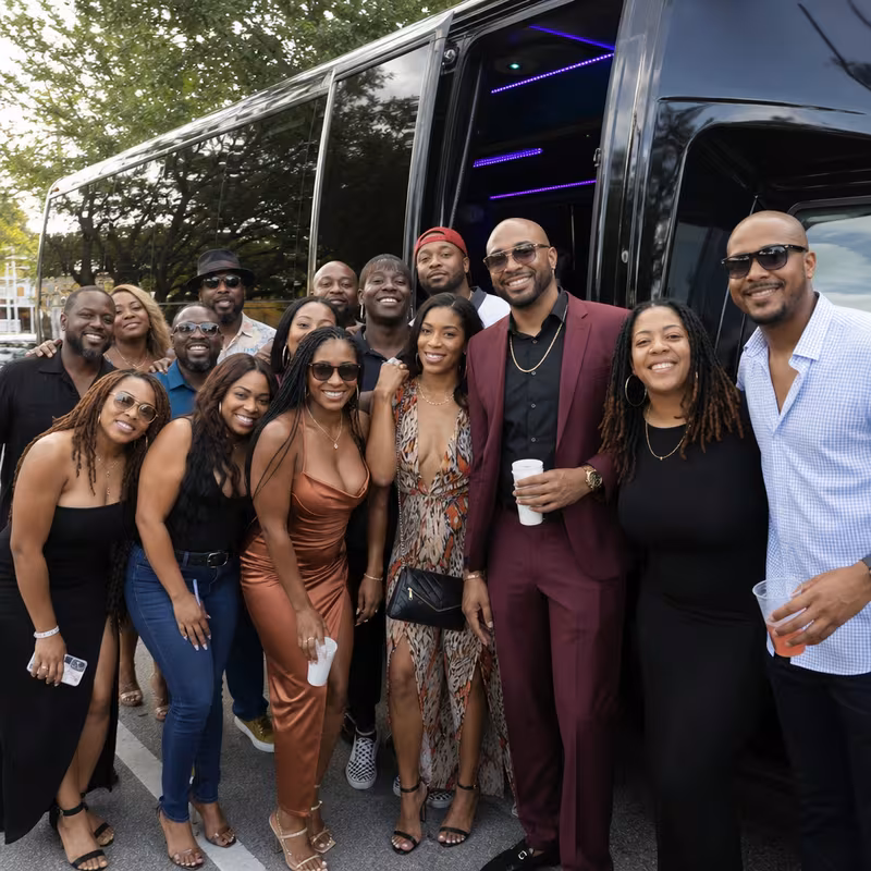 Group boarding a white charter bus for Birthday Transportation transportation in Miami