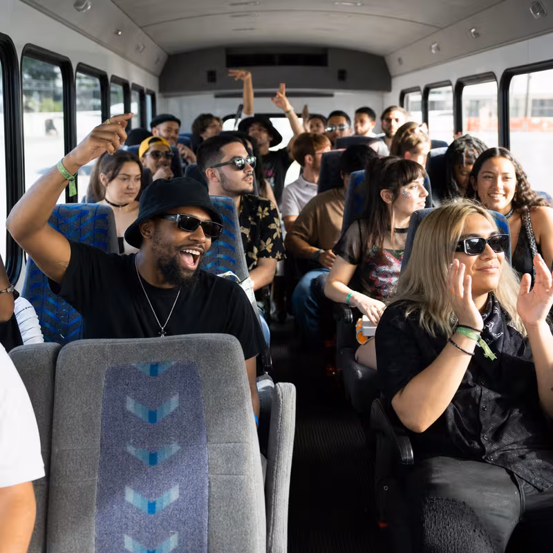 Party bus interior with wraparound leather seating and LED lighting in Miami