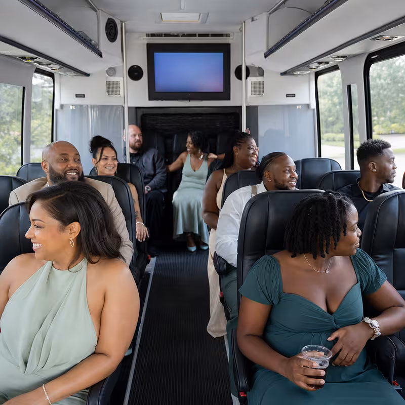 Group boarding a white charter bus for Private Event Transportation transportation in Miami