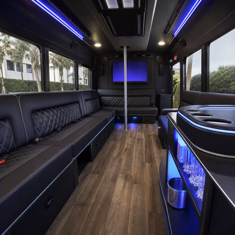 Party bus interior with wraparound leather seating and LED lighting in Miami