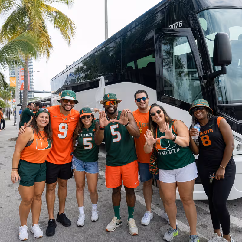 Passengers loading luggage while boarding a Miami group shuttle