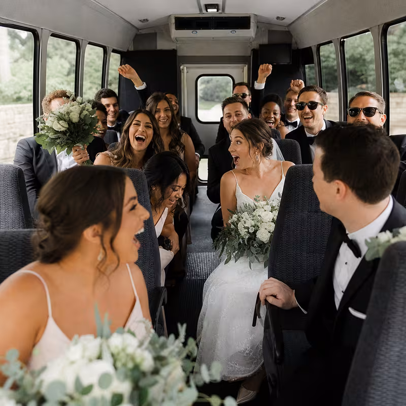 Group boarding a white charter bus for Wedding Transportation transportation in Miami